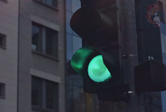 Green traffic light signaling safe passage for vehicles, relevant to road test preparation and understanding traffic signals.