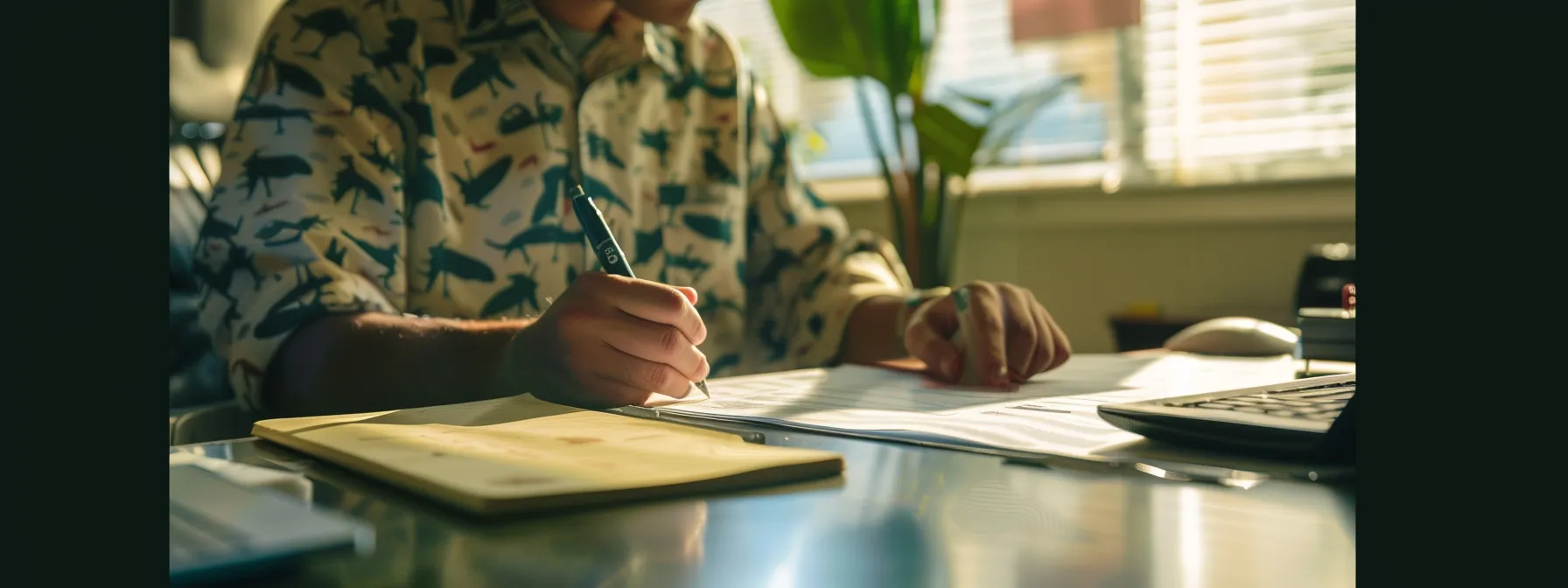 a person sitting at a desk, taking a written driving test at the dmv.