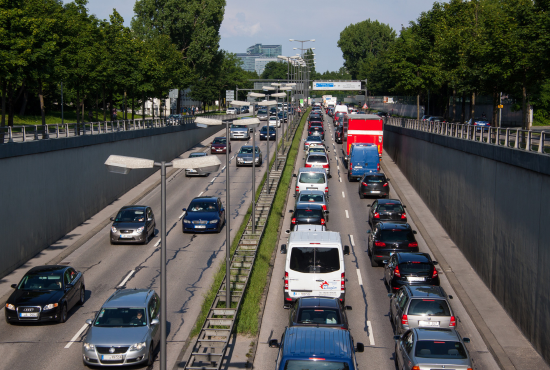 Traffic congestion on a highway with various vehicles including cars and trucks, illustrating the challenges of highway driving relevant to road test preparation.