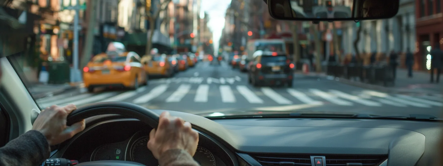 a driver confidently uses their turn signal while yielding to pedestrians at a crosswalk during the nyc driving test.